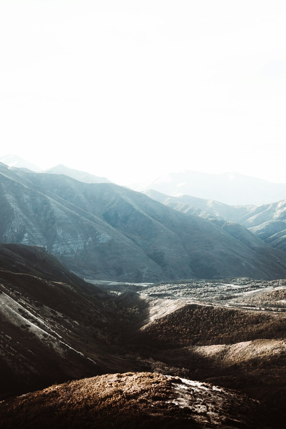 a view of a valley with mountains in the background