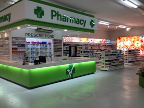 Pharmacist assisting a customer at a pharmacy counter.