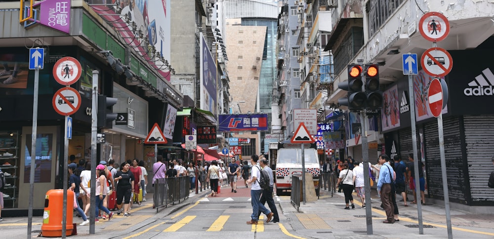 people walking on roads beside buildings during daytime