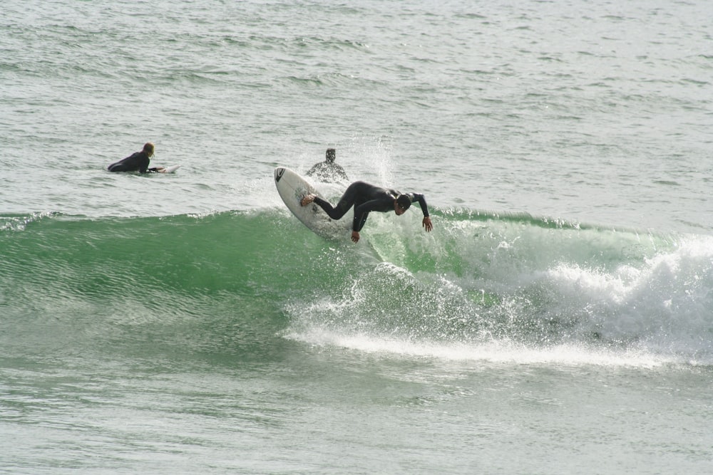 man surfboarding on waves