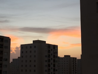 Modern high-rise residential building in Ajman at sunset