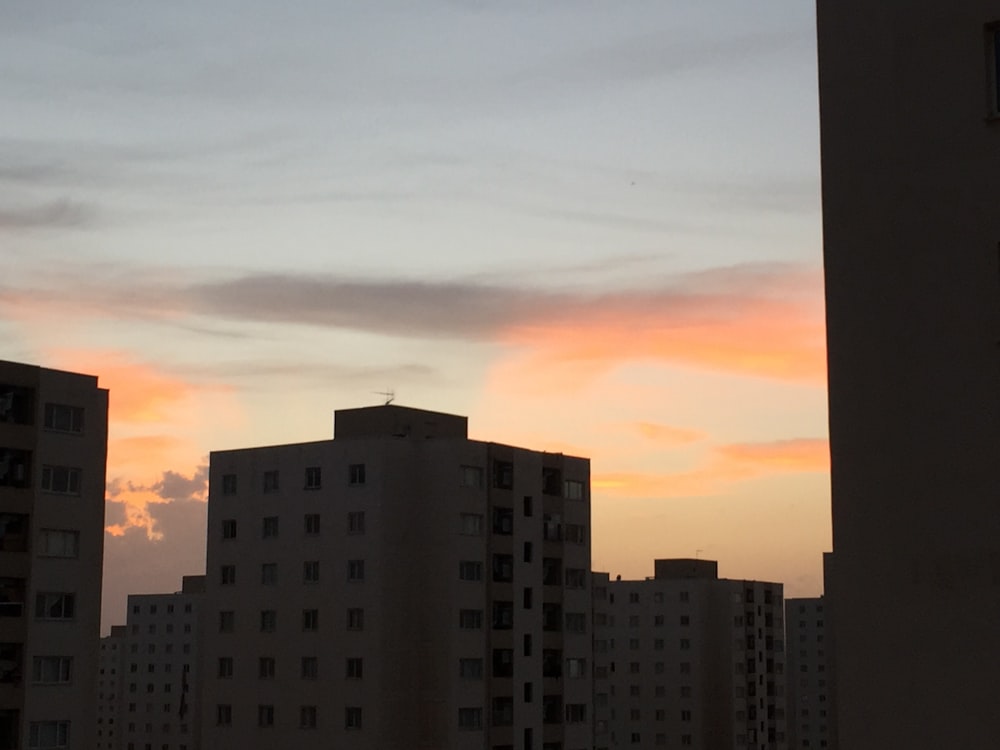 orange sky over city skyline at dusk