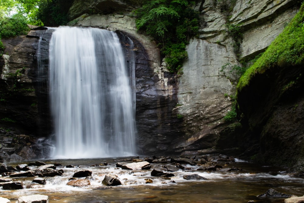 waterfalls beside rock formation