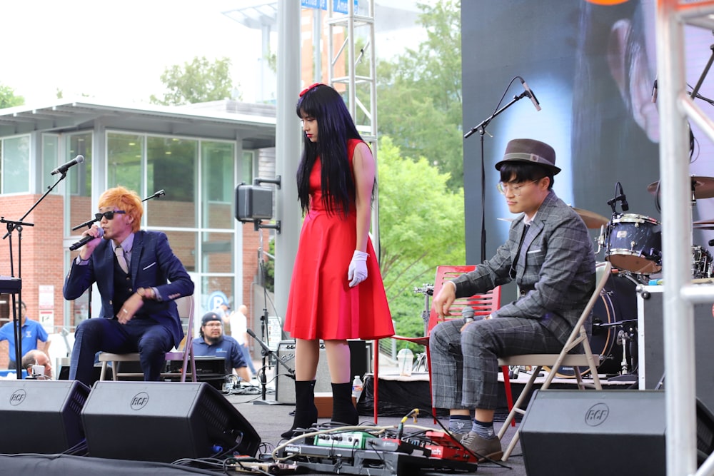 woman and two men performing on stage