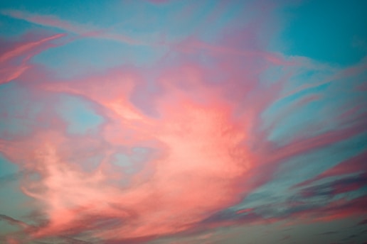 A vibrant painting of a vast sky filled with swirling clouds and rich colors, capturing the emotional depth typical of Gaetano Siniscalchi's work.