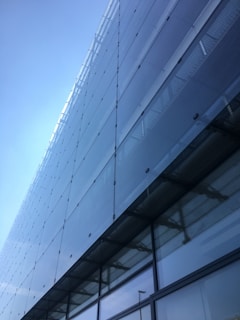 Modern office building facade seamlessly integrated with Lumirex BIPV solar glass panels reflecting the sky.