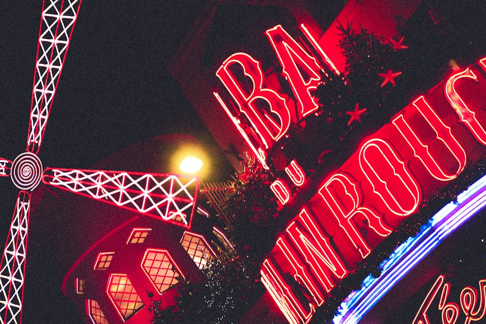 a red and white sign and some buildings and lights