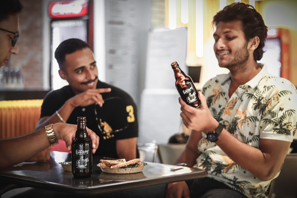 three men drinking beer