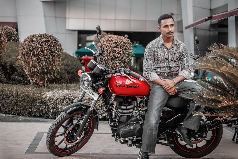 man on a red and black motorcycle