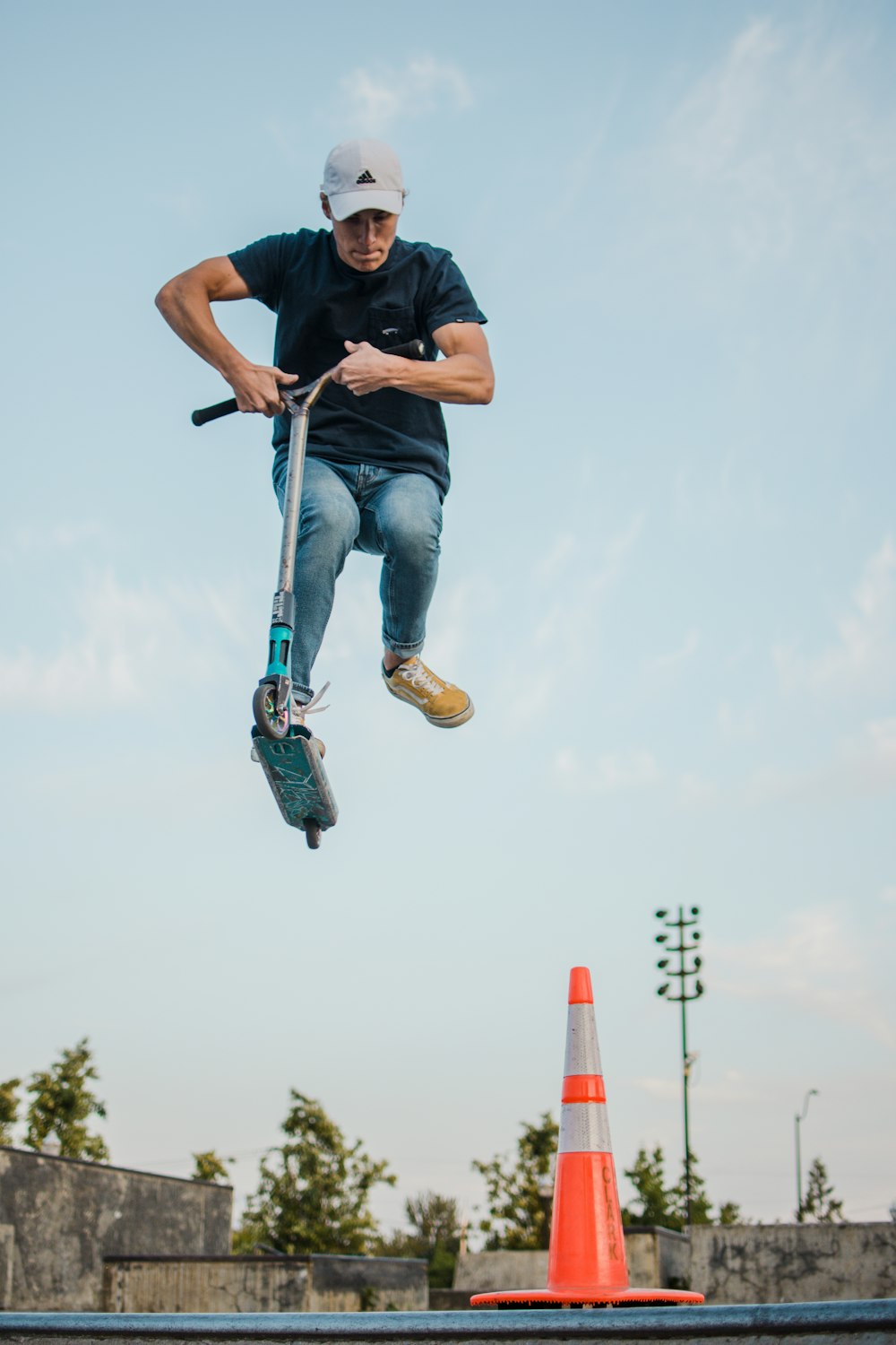 man doing tricks on a kicking scooter