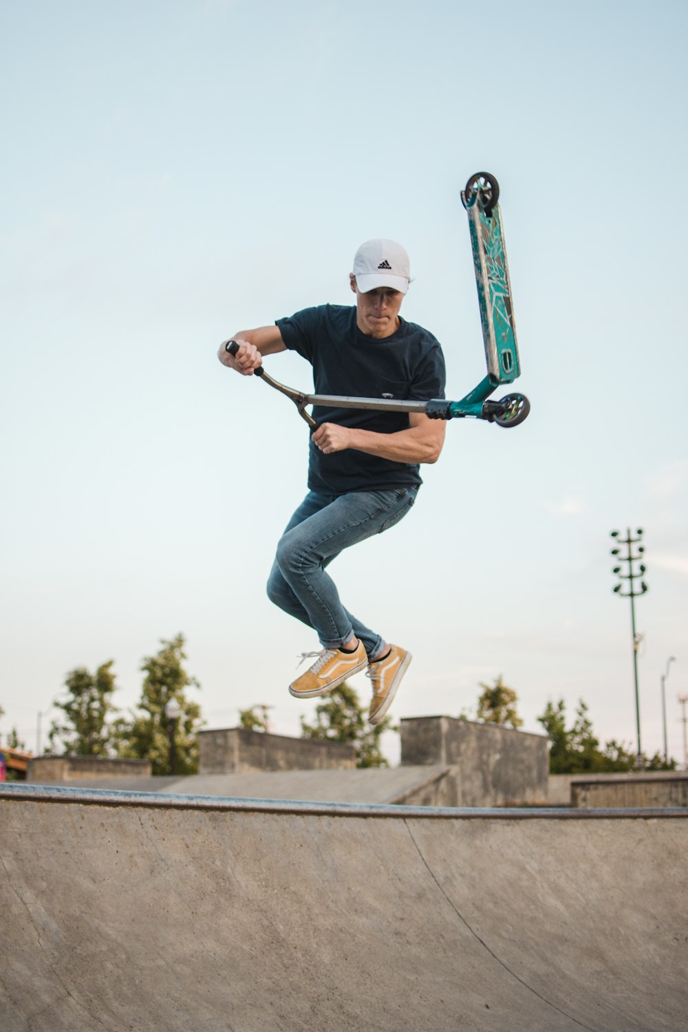 man doing tricks on a kick scooter