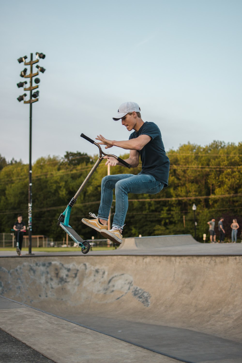 man jumping with kick scooter