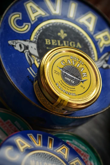 Artisan packaging of Perlanera’s premium caviar selection displayed on a rustic wooden table.