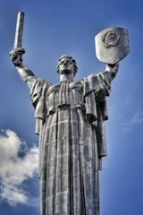 adipr standing tall amid swirling tornado winds, sword gleaming.