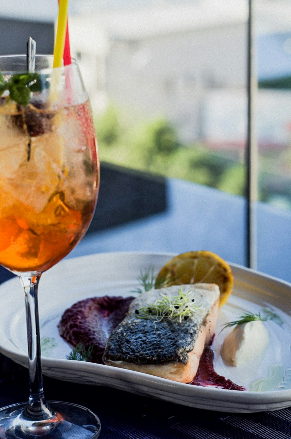 plate of food near filled cocktail glass