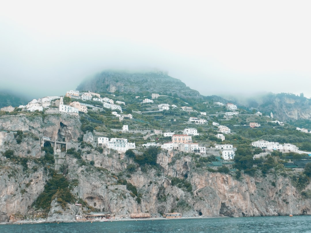 buildings on rock mountain near ocean