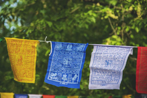three yellow, blue, and white hanging decors