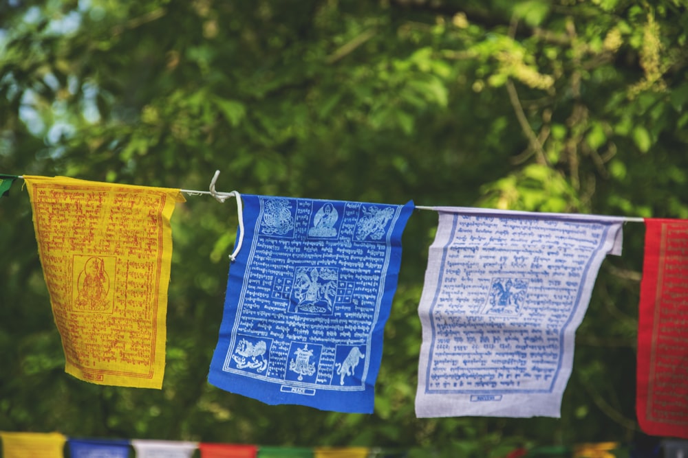 three yellow, blue, and white hanging decors