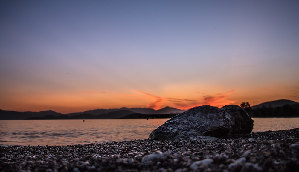 silhouette photo of stone during golden hour