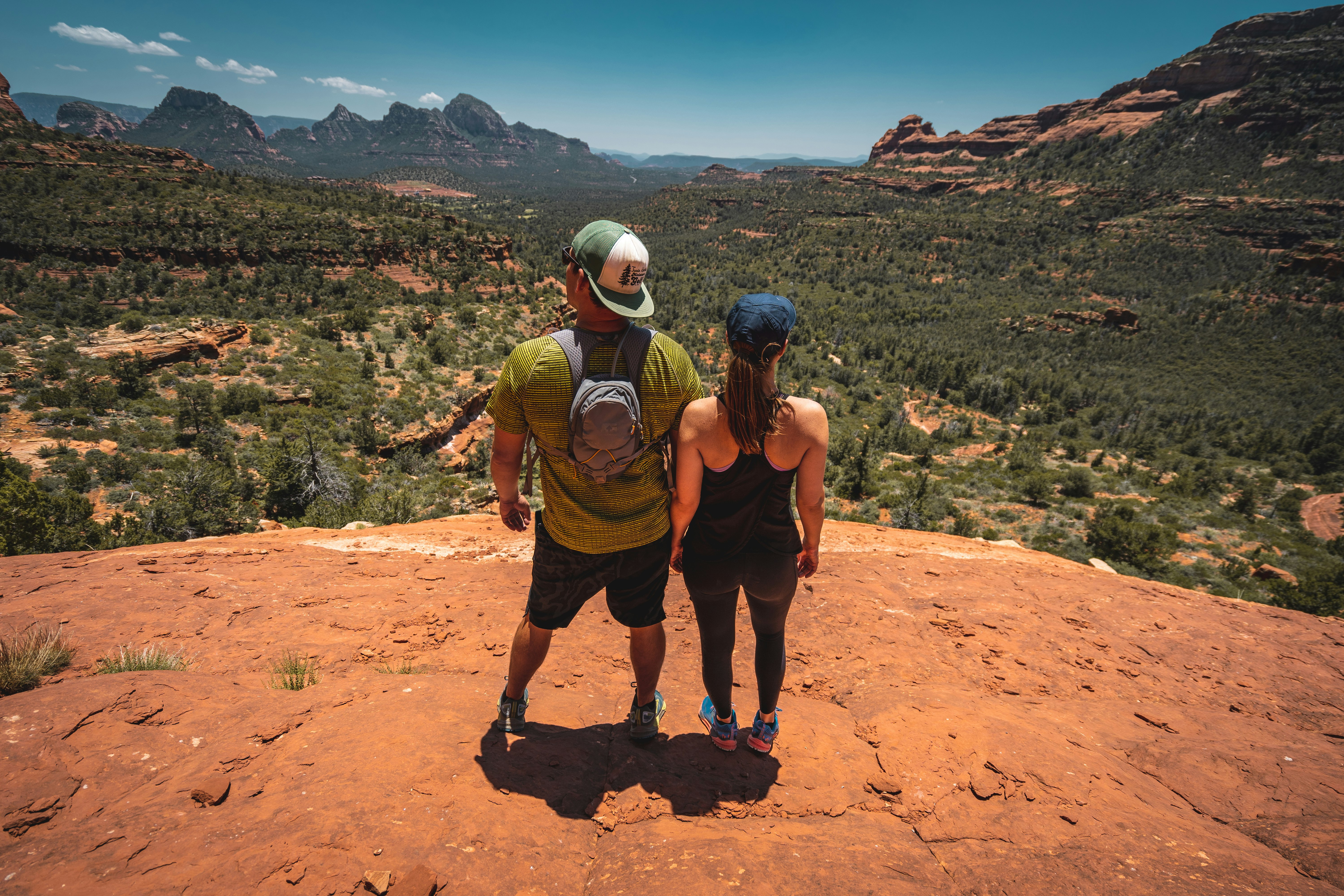 man and woman standing on hill