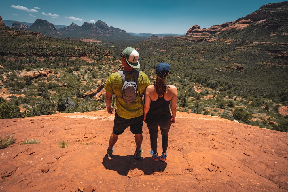 man and woman standing on hill