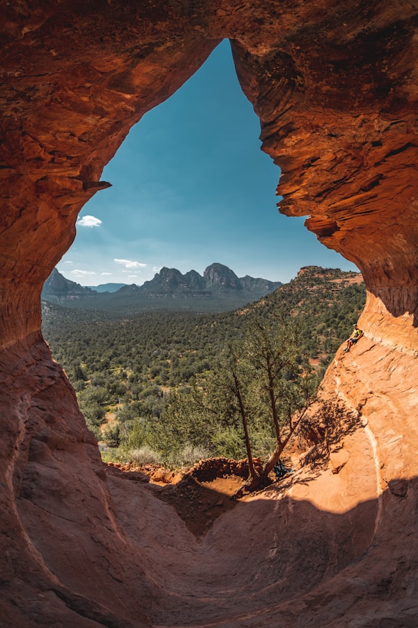 A sunlit desert cave in warm earth tones, the obscure work of becoming before the world ever sees it