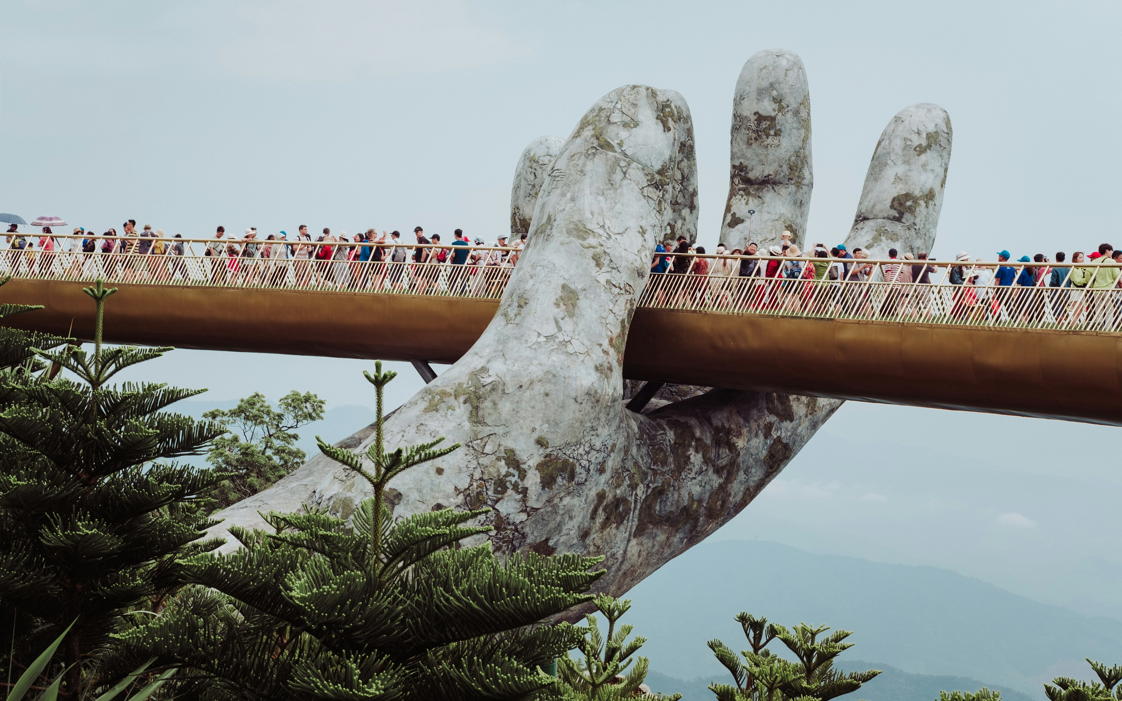 Golden Bridge held by giant stone hands at Ba Na Hills