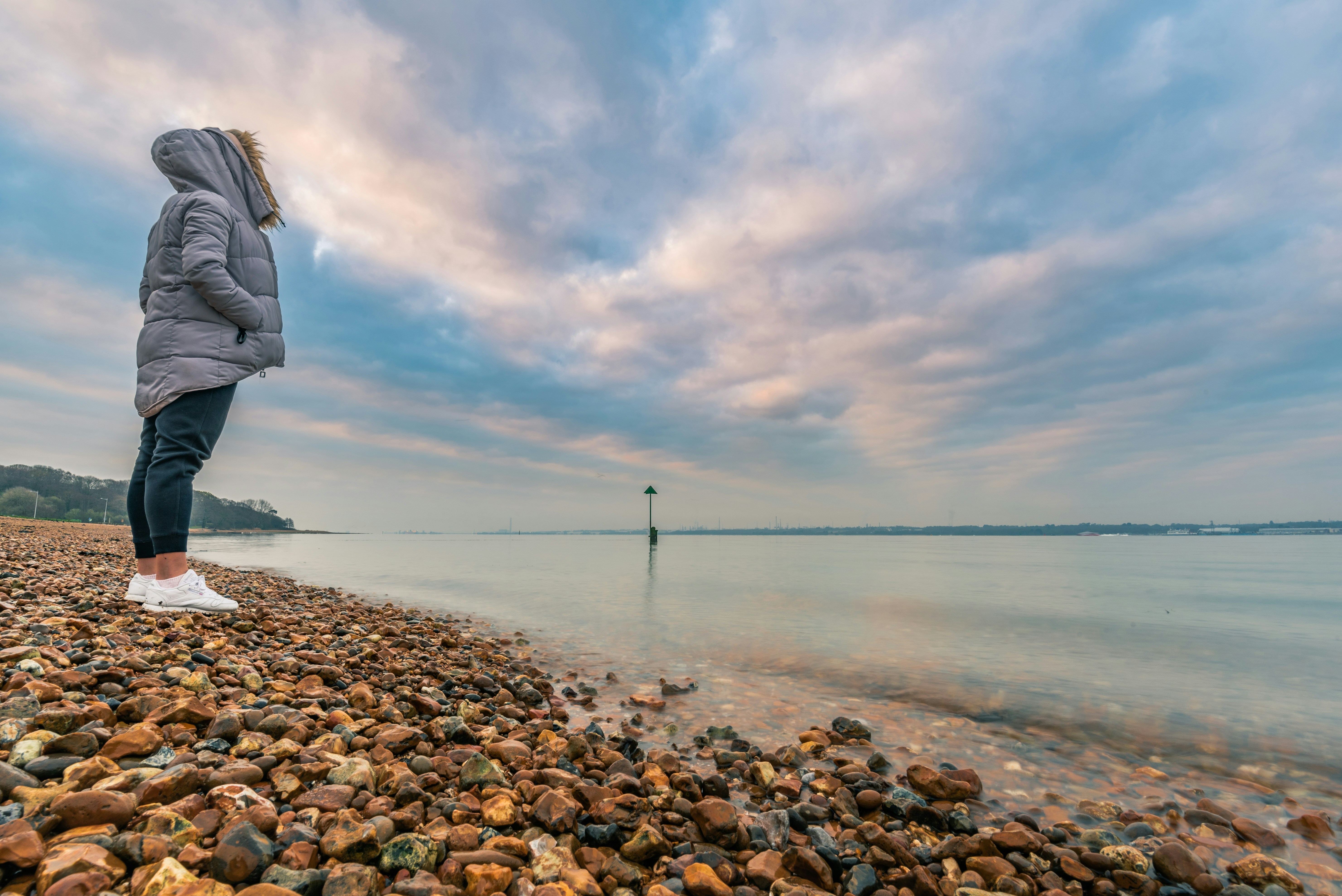 woman standing beside seashore during daytime