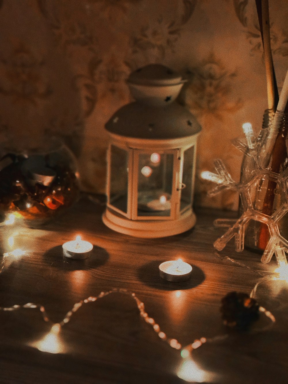 white candle lantern near lit candles