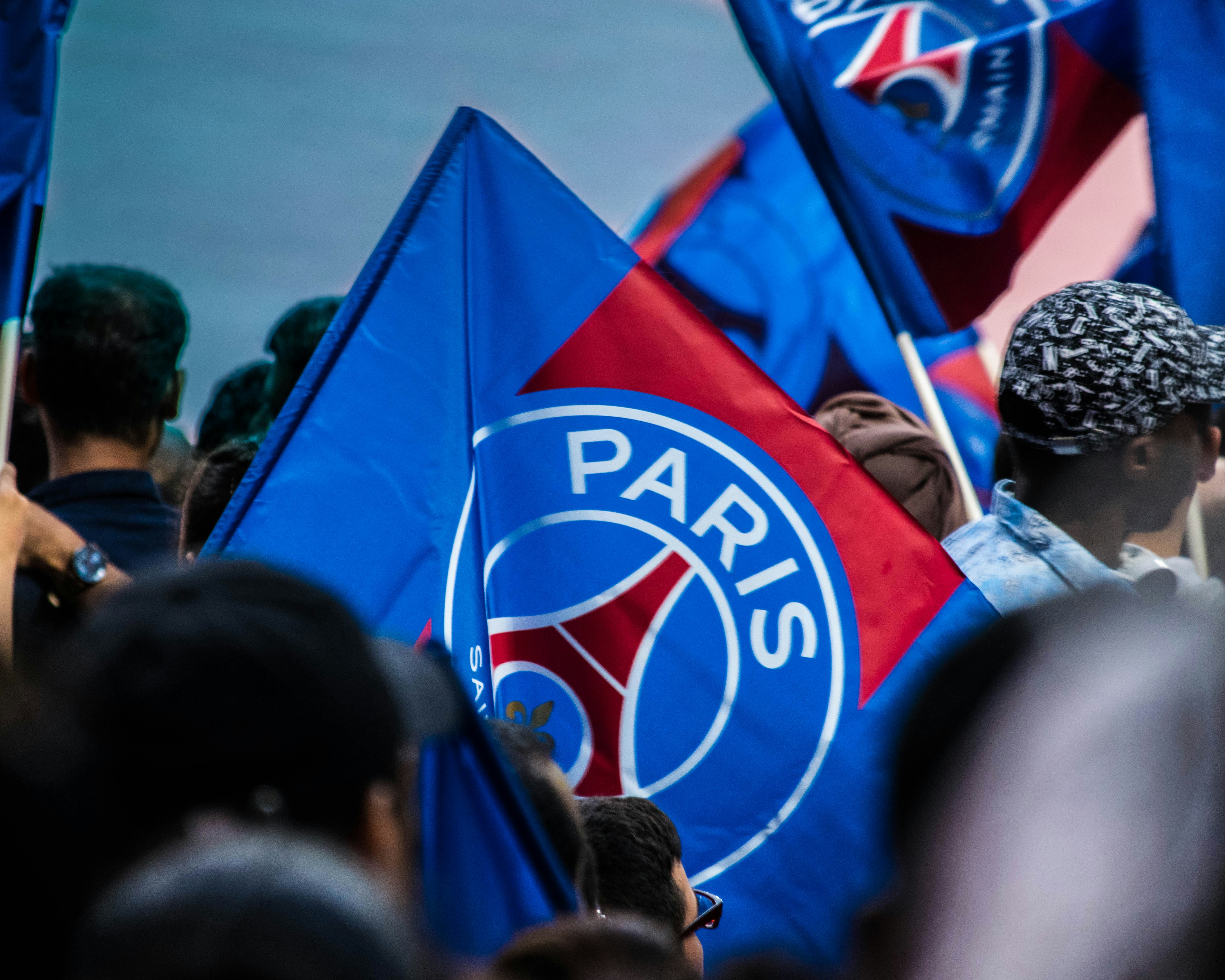 A fan flying the Paris Saint-Germain, PSG flag