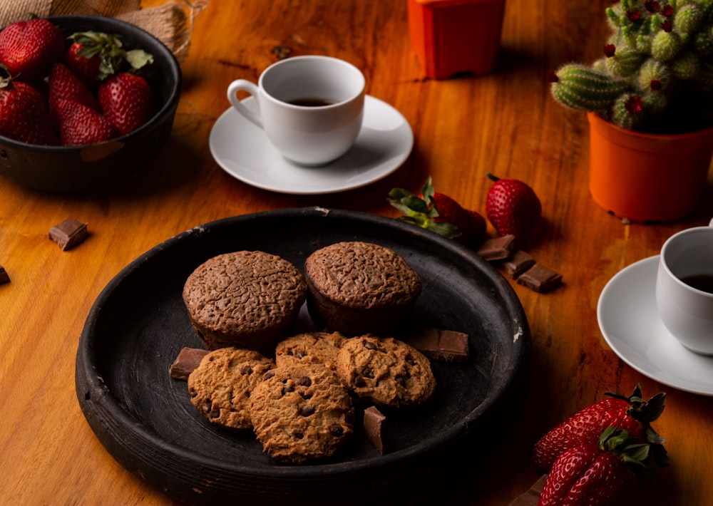 cookies in plate beside cup and saucer