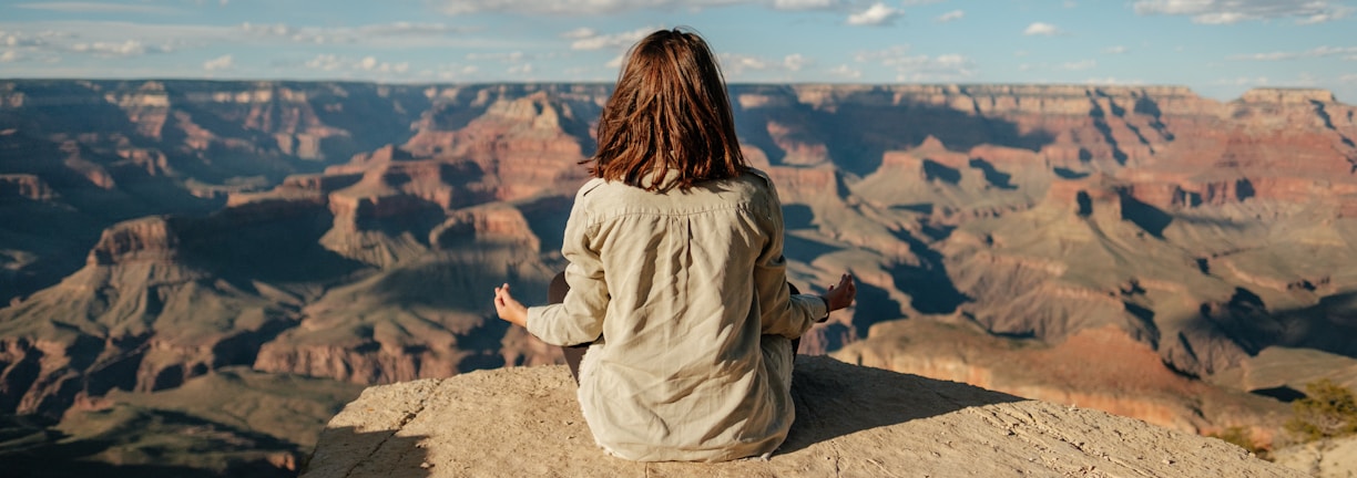 woman sitting on hill