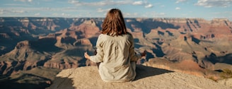 woman sitting on hill