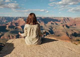 woman sitting on hill