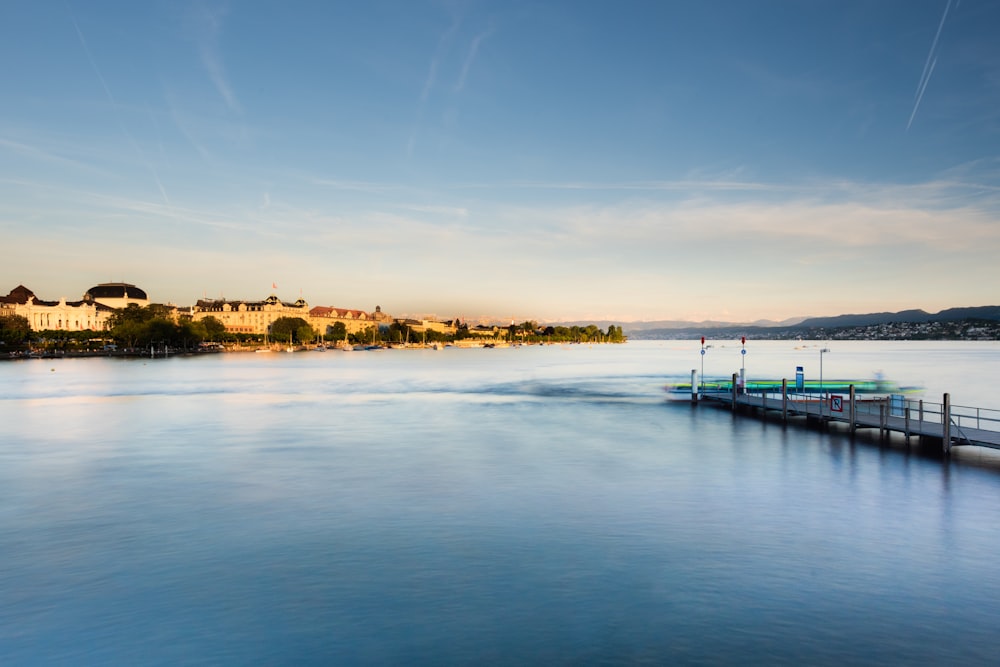 photography of buildings beside body of water during daytime