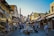 A vibrant street scene in Fes with tourists exploring traditional markets and historic architecture.