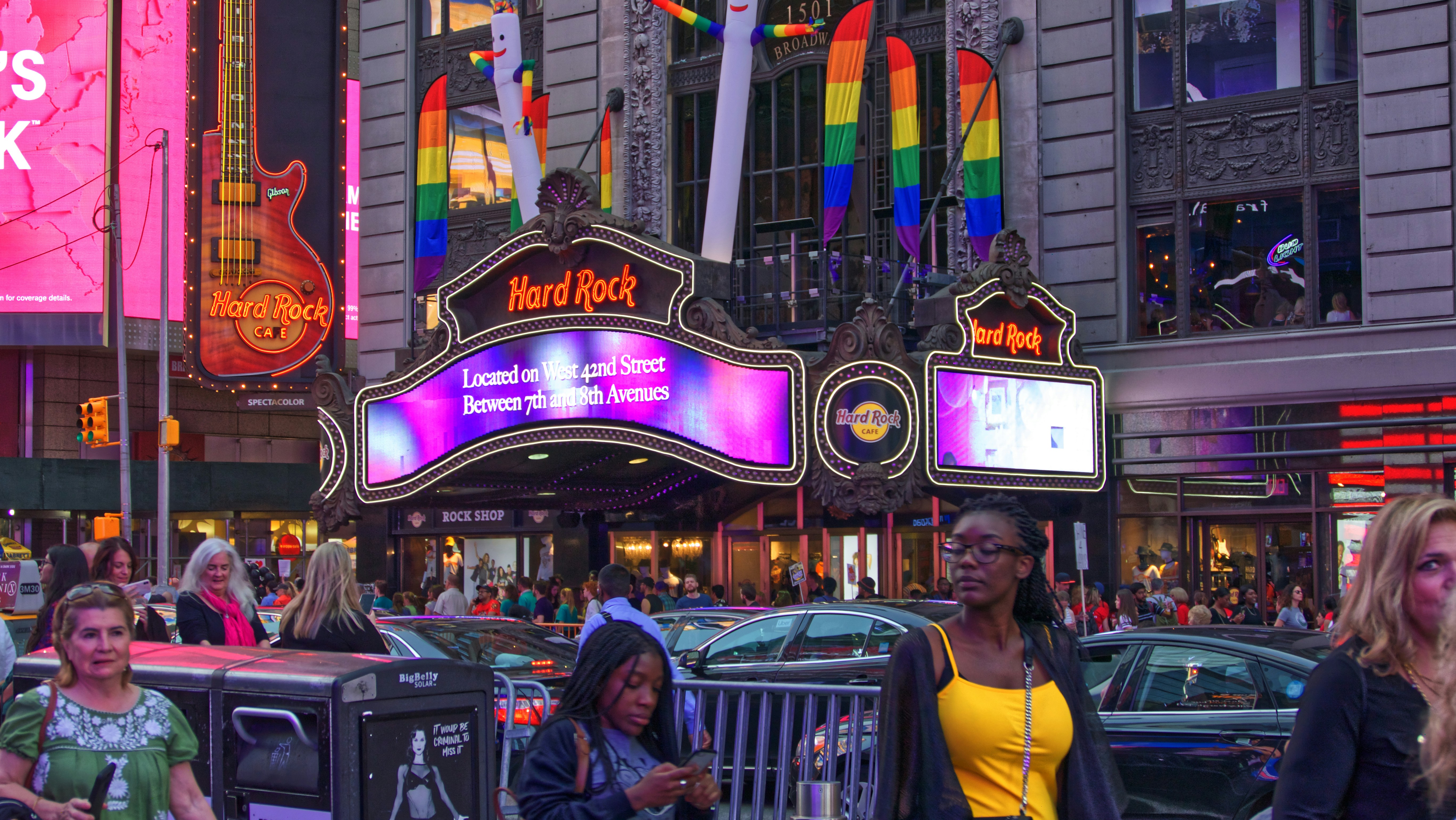 group of people walking beside Hard Rock cafe