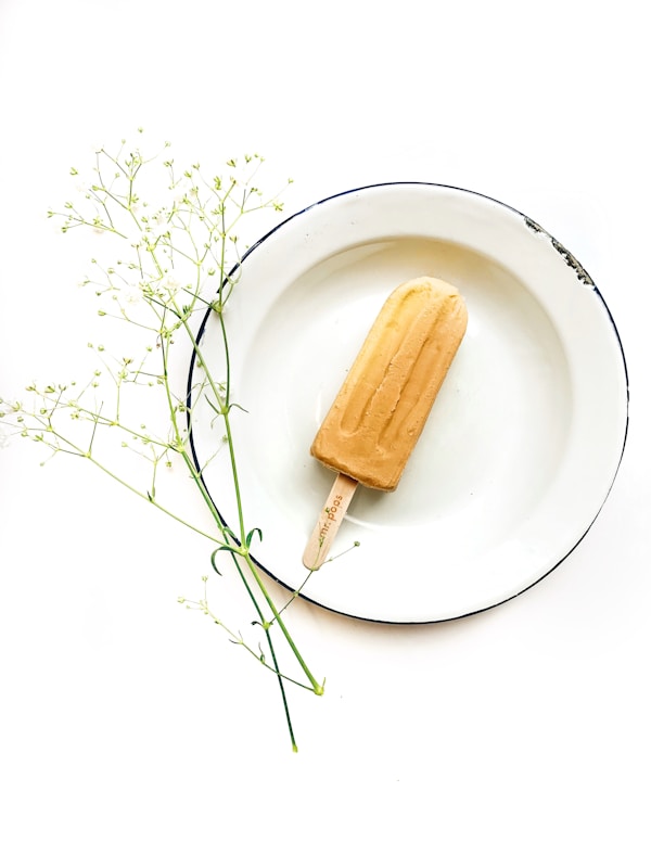 Ice cream pop on white plate