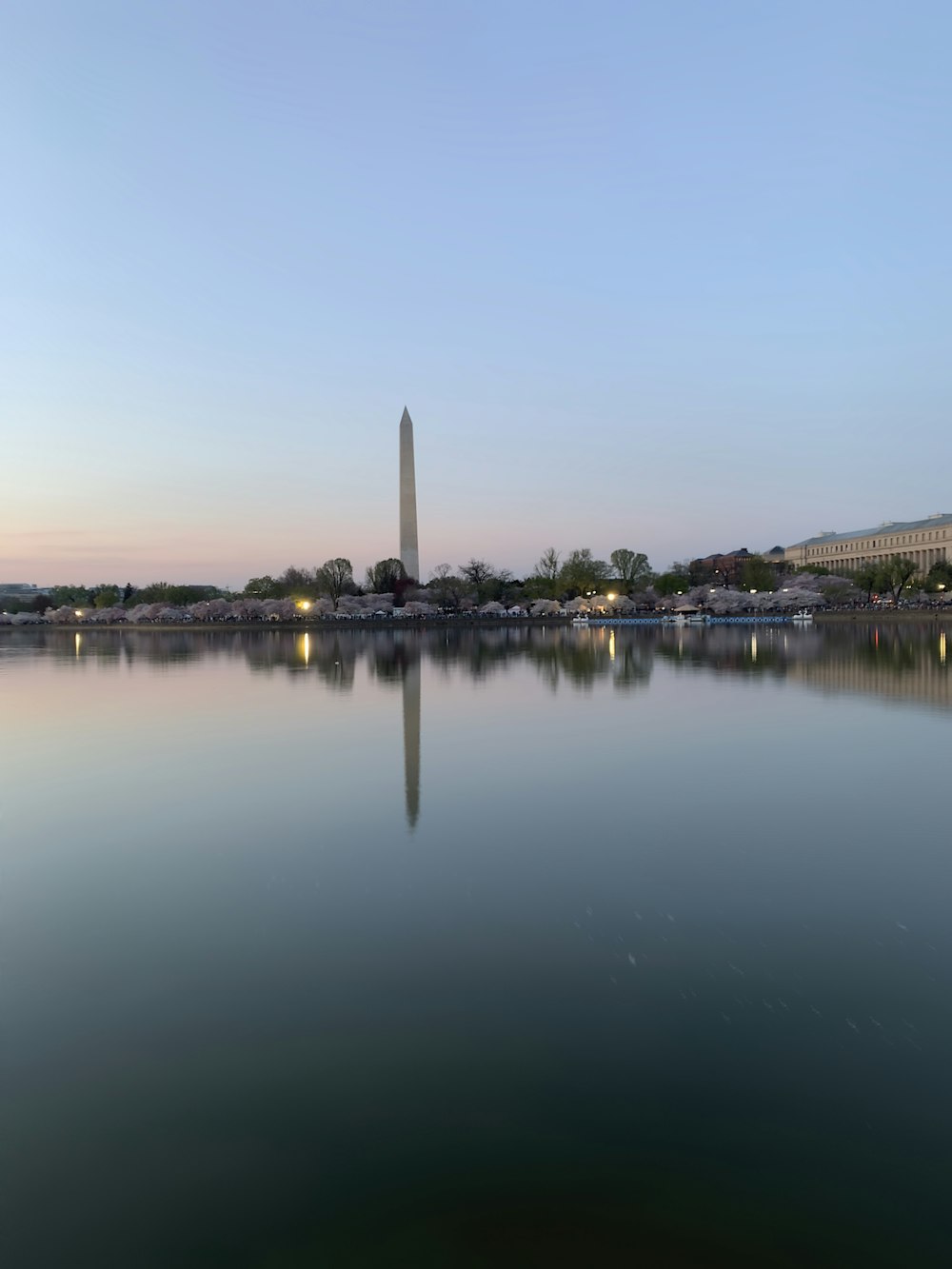 a large body of water with a tall tower in the background