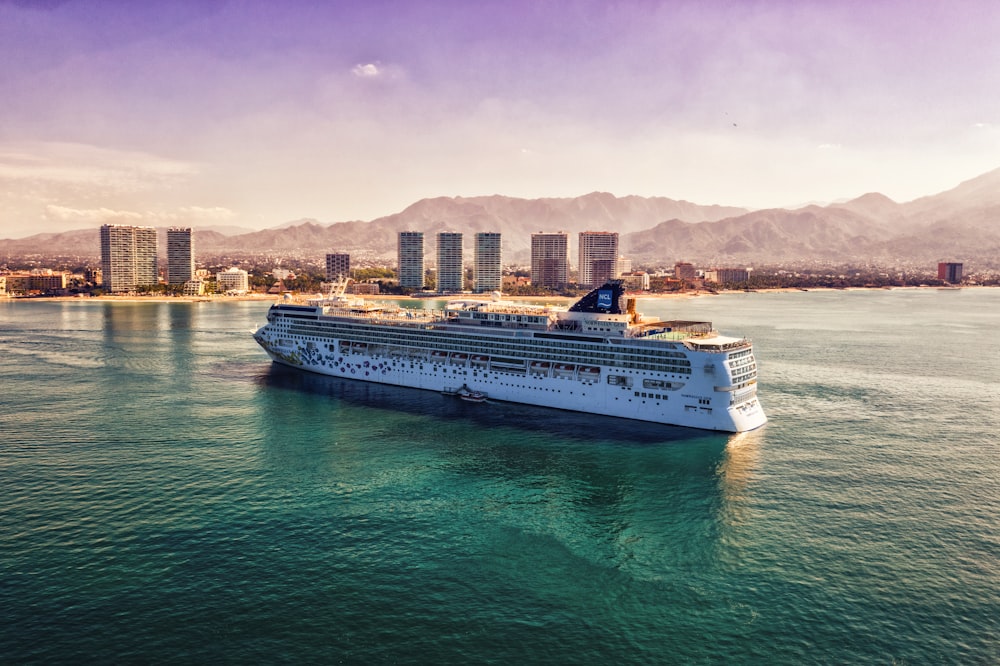 white and blue boat on body of water during daytime