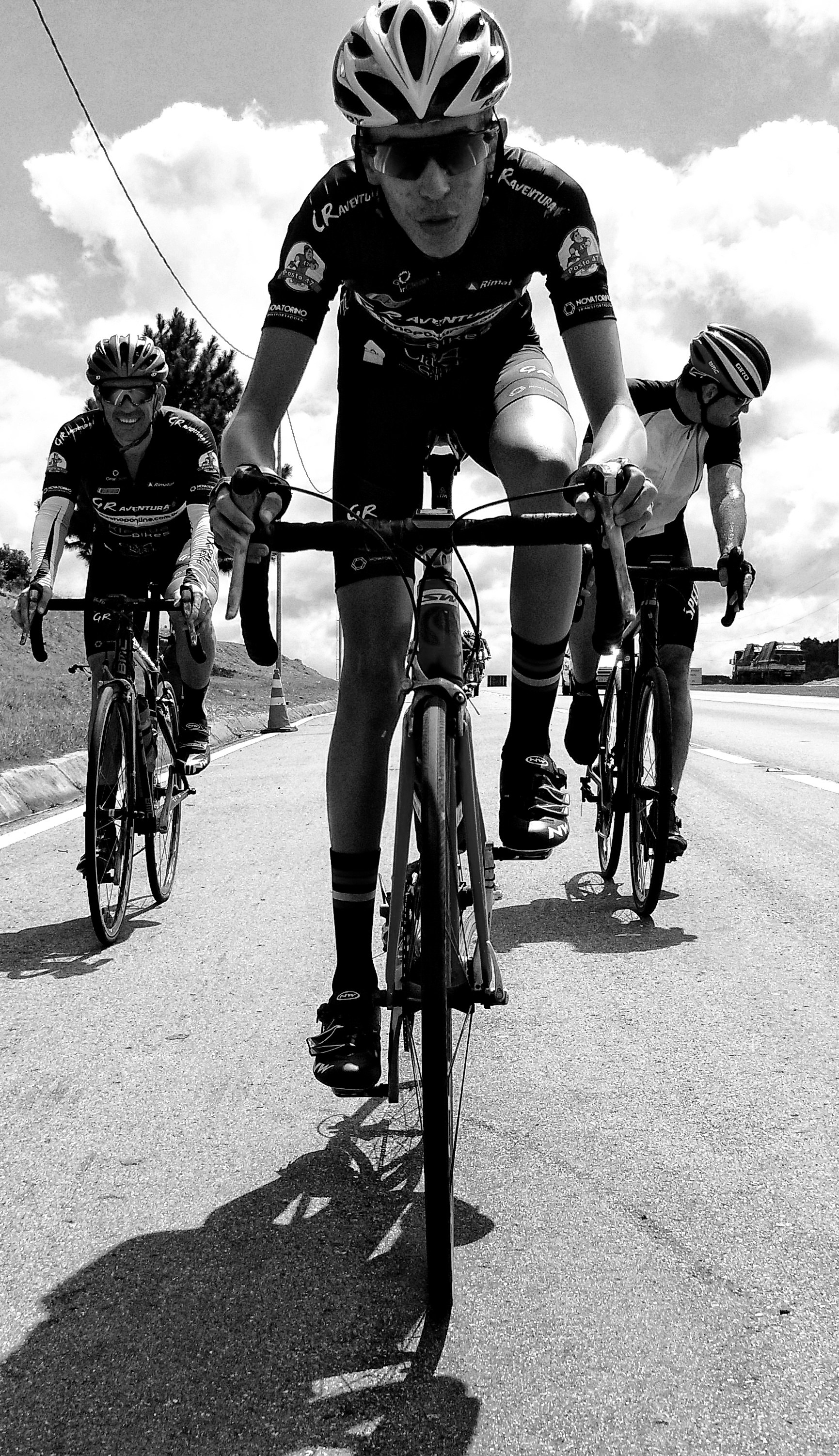 grayscale photography of unknown persons driving bicycle outdoors