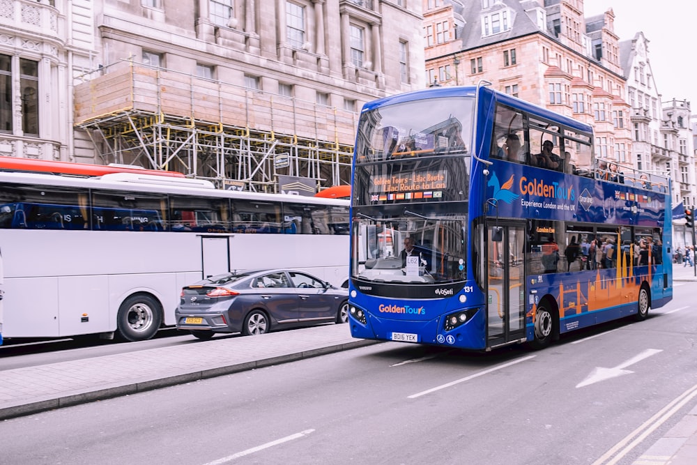 blue double-decker bus on paved road