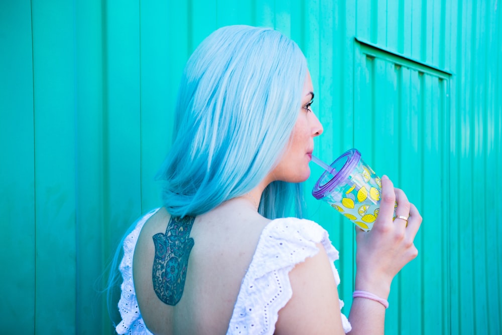 woman holding blue tumbler