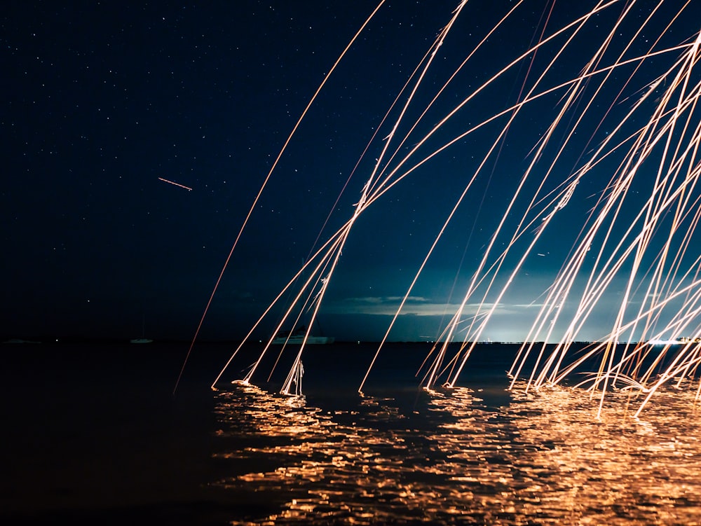 a body of water under a night sky filled with stars