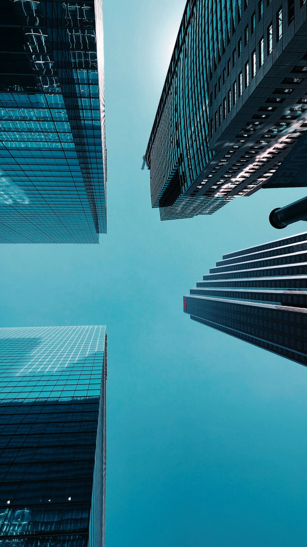 low angle photography of four gray concrete buildings