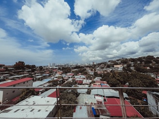 A panoramic view of a residential area with various fence styles.
