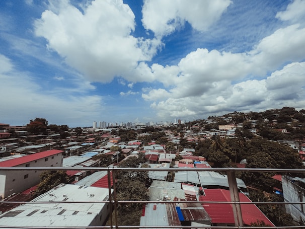 A panoramic view of a residential area with various fence styles.