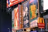 a bunch of billboards that are on the side of a building