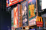 a bunch of billboards that are on the side of a building