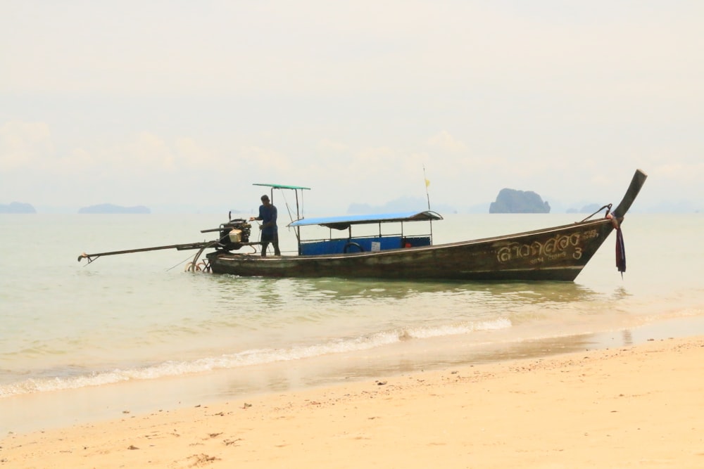 person standing on white canoe boat